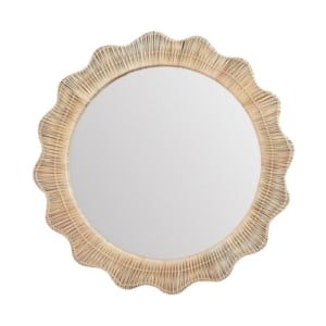 A round wicker mirror with a scalloped white frame.