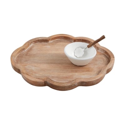 A wooden serving tray with a scalloped decor, a spoon, and a bowl.