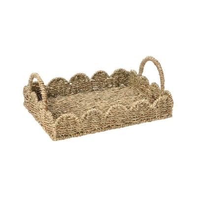 A scalloped wicker serving tray with handles.