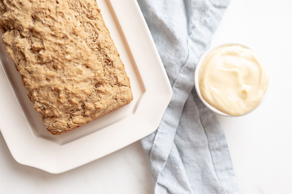 beer bread on a white platter, butter to the side