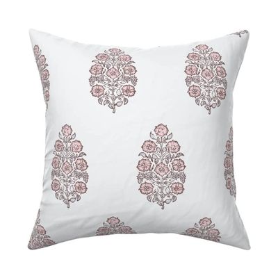A pink and white block print Amazon pillow cover
