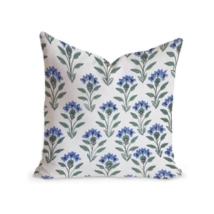 A pillow adorned with beautiful blue flowers available on Amazon.