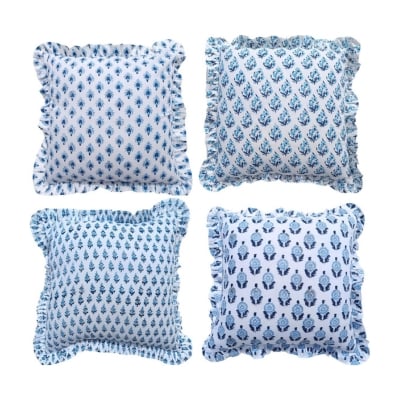 Set of four blue and white pillows with ruffled edges, perfect for your home decor.