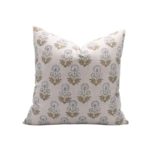 A pillow with a blue and gold floral pattern, available on Amazon.