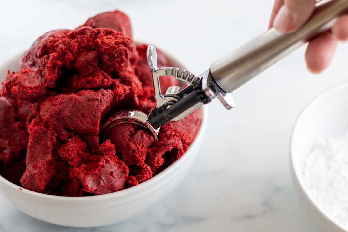 Red velvet gooey butter cookie dough in a mixing bowl.