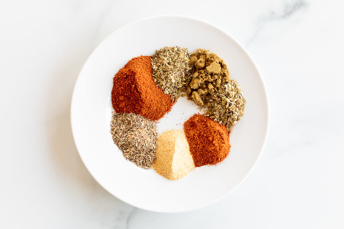 Overhead view of chipotle seasoning ingredients on plate