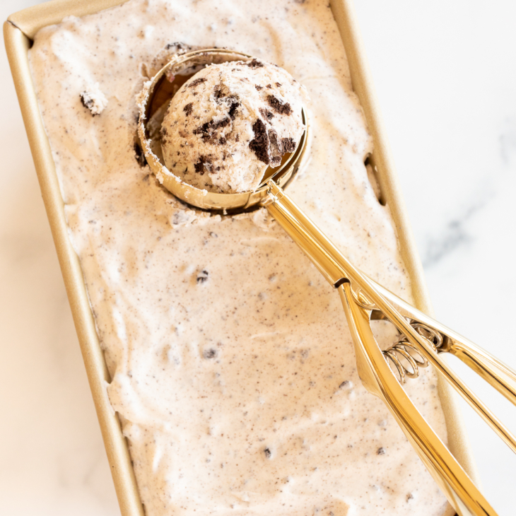 Ice cream scooper in pan of no-churn cookies and cream ice cream