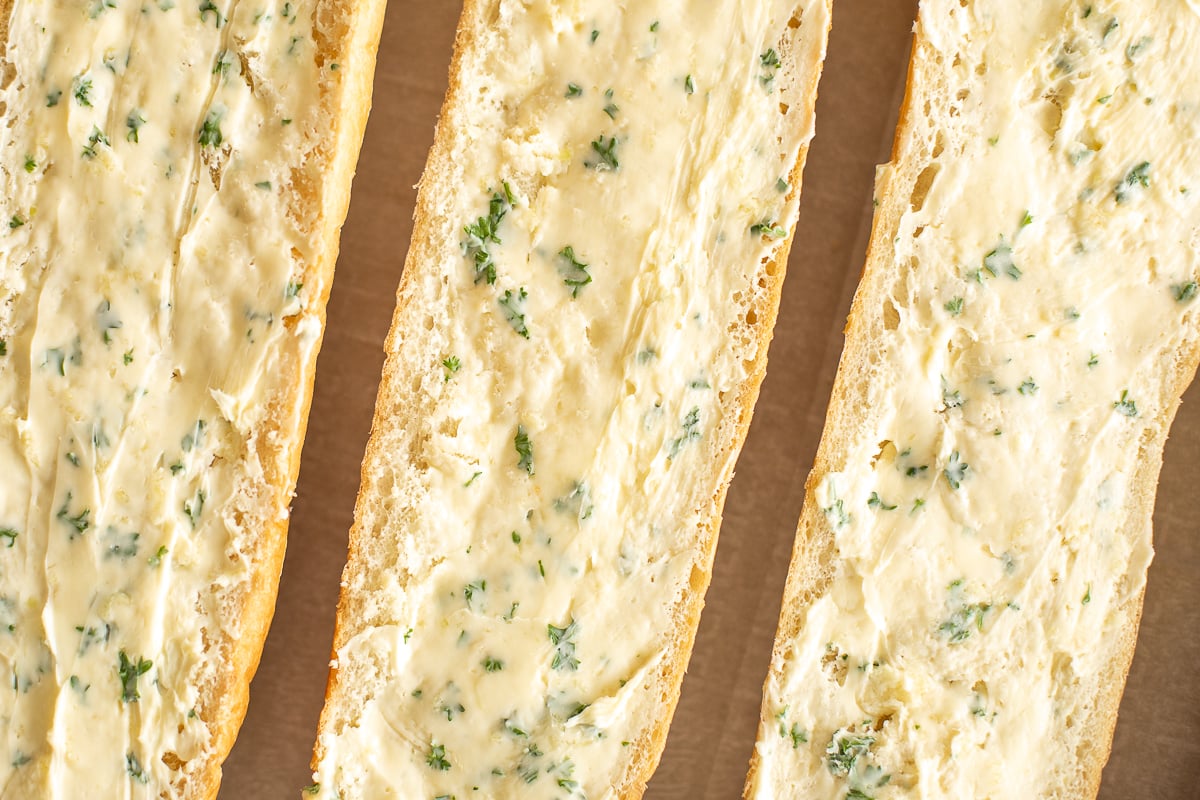 Overhead view of French bread with garlic butter spread on top