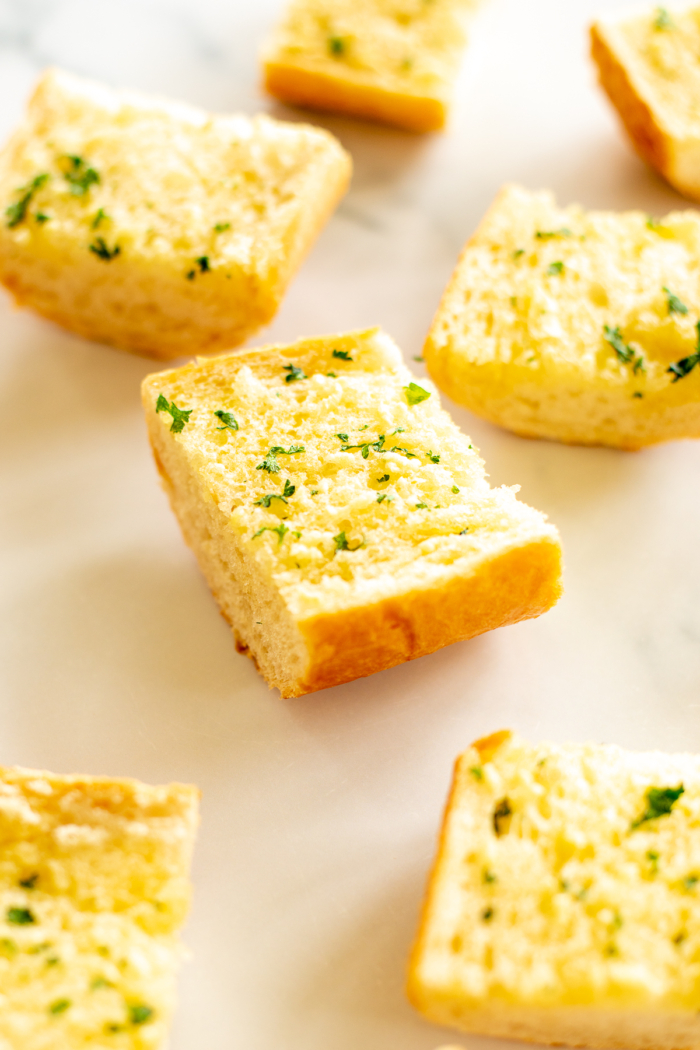 Slices of homemade garlic bread on marble countertop