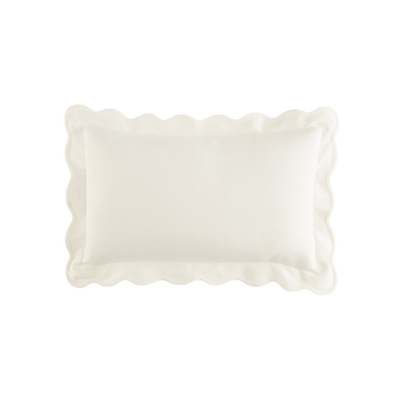 a white scalloped outdoor pillow