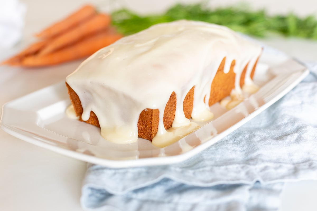 A carrot cake loaf topped with cream cheese glaze