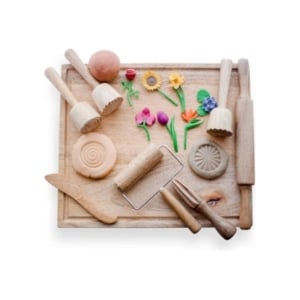 A wooden cutting board filled with a variety of kitchen utensils, perfect as an Easter basket filler.