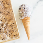 Oreo desserts ice cream in a waffle cone.