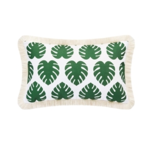 An outdoor green and white pillow with a fringe trim.