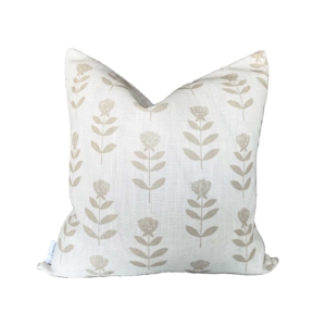 A pillow with a beige and beige floral pattern suitable for outdoor use.