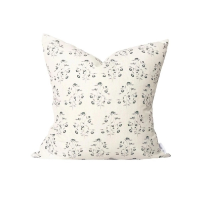 A cream patterned outdoor pillow