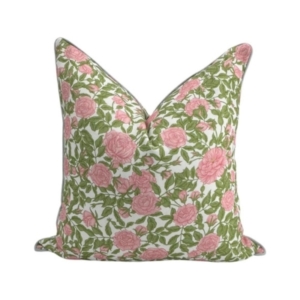 An outdoor pillow with a pink and green floral pattern.