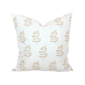 An outdoor white pillow with a floral design.