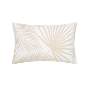 An outdoor white and tan pillow with palm leaves on it.