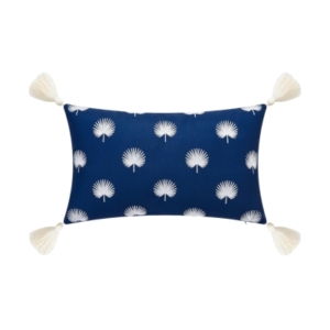 An outdoor blue and white pillow with tassels on it.
