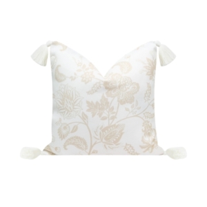An outdoor white and beige pillow with tassels.