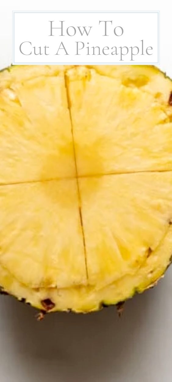 A fresh pineapple that is cut across the center in a guide on how to cut a pineapple.