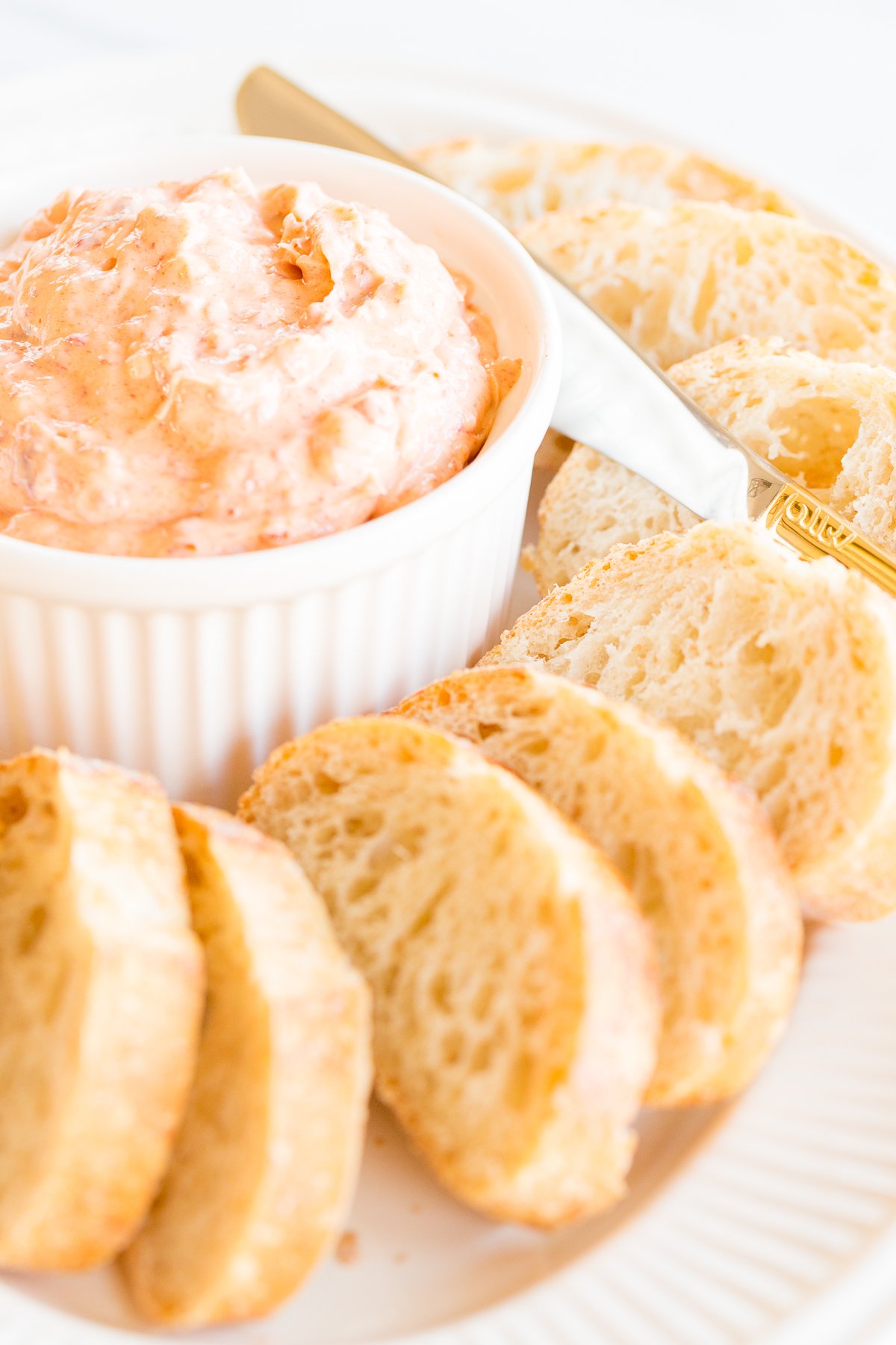 a bowl of pimento cheese surrounded by crostini