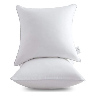 Two white pillow inserts are stacked vertically against a plain background.