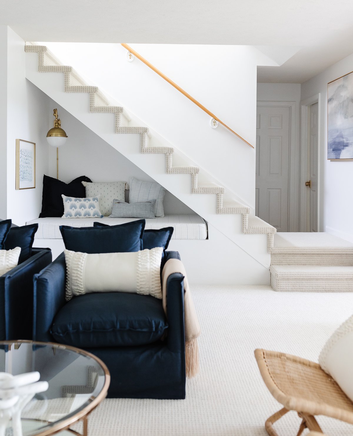 under stairs reading nook in white and blue living room