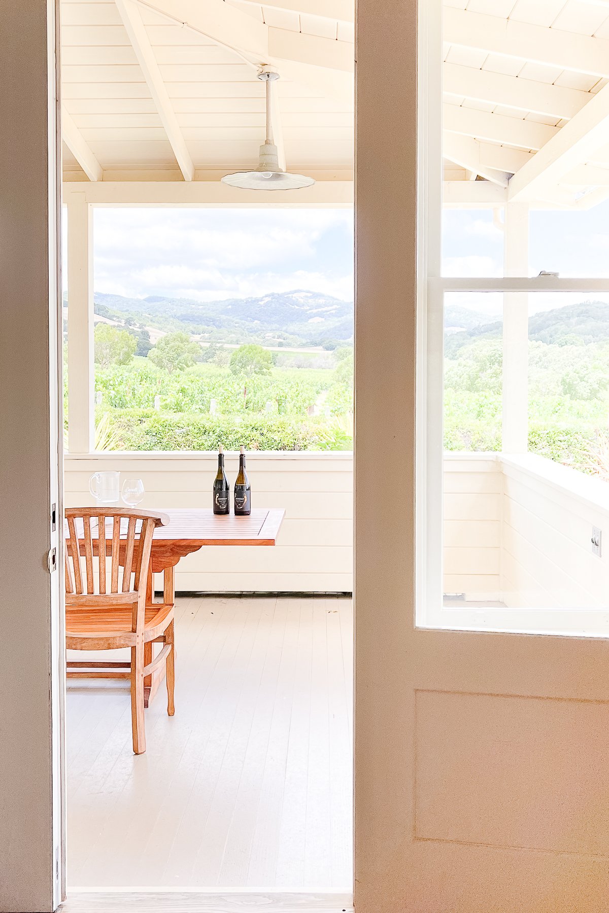 A white porch in a guide to deck paint colors.