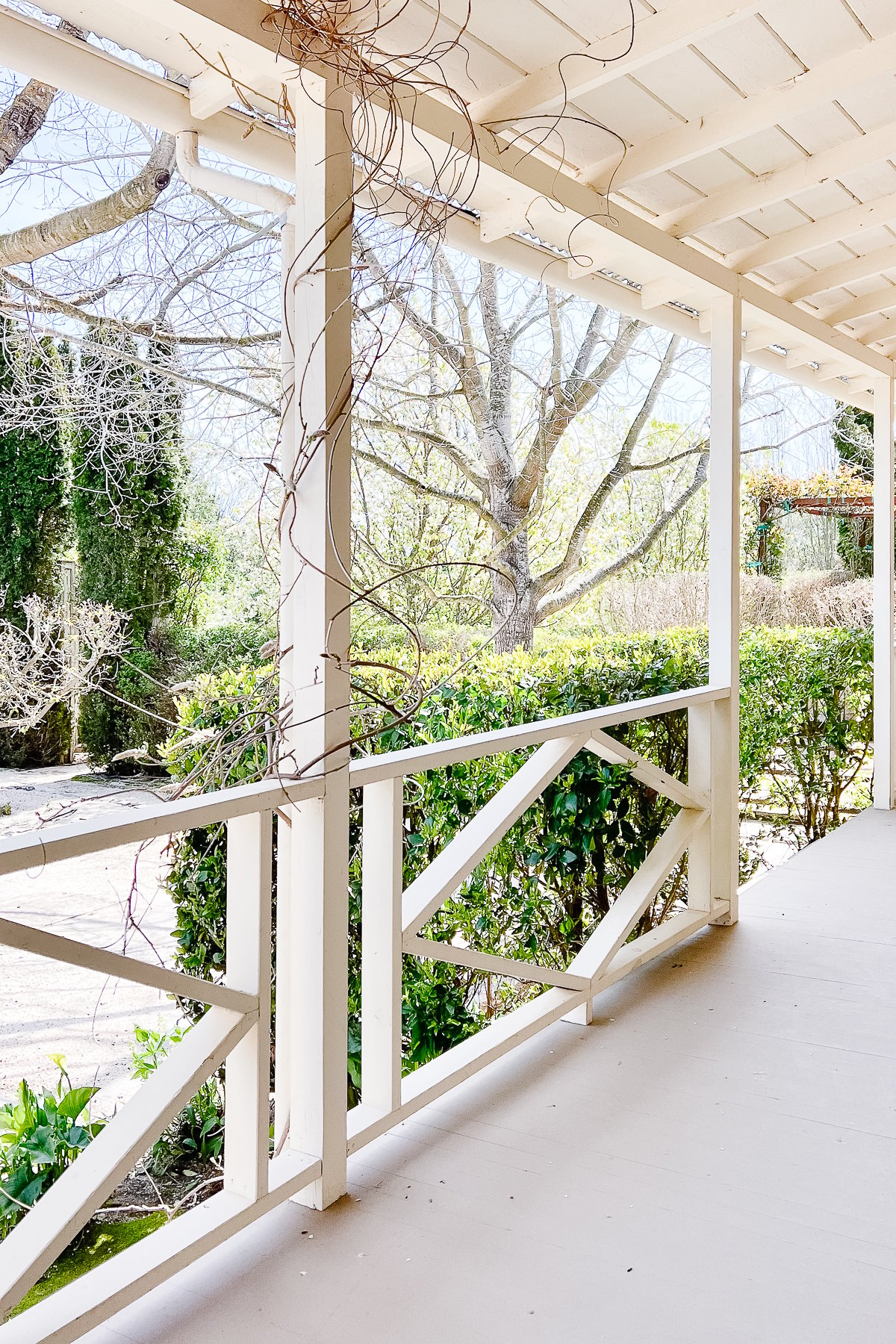 A covered deck, painted in a soft gray color.