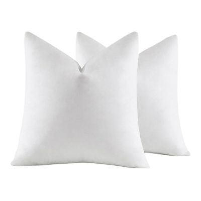 Two white pillow inserts with a slightly textured surface stand upright against a plain white background, offering a simple yet elegant aesthetic.