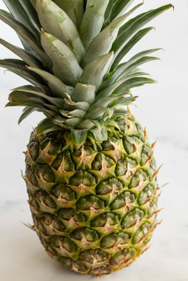 A fresh pineapple on a marble countertop