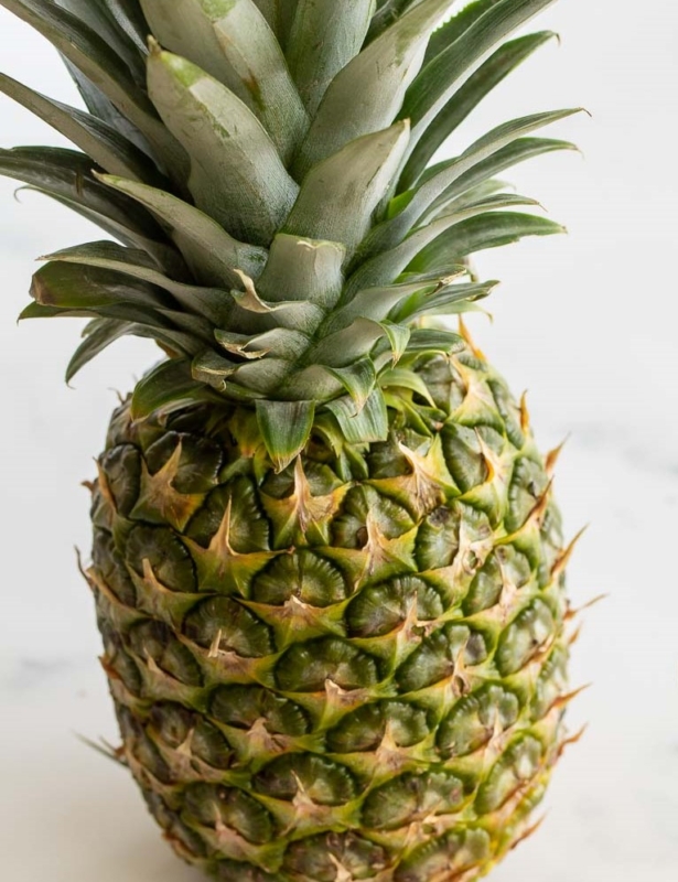 A fresh pineapple on a marble countertop