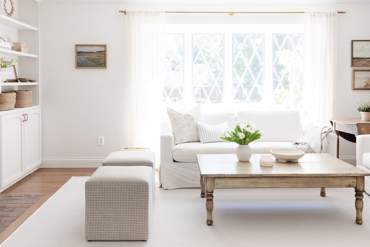 A living room with white walls, white furniture and minimalist decorating