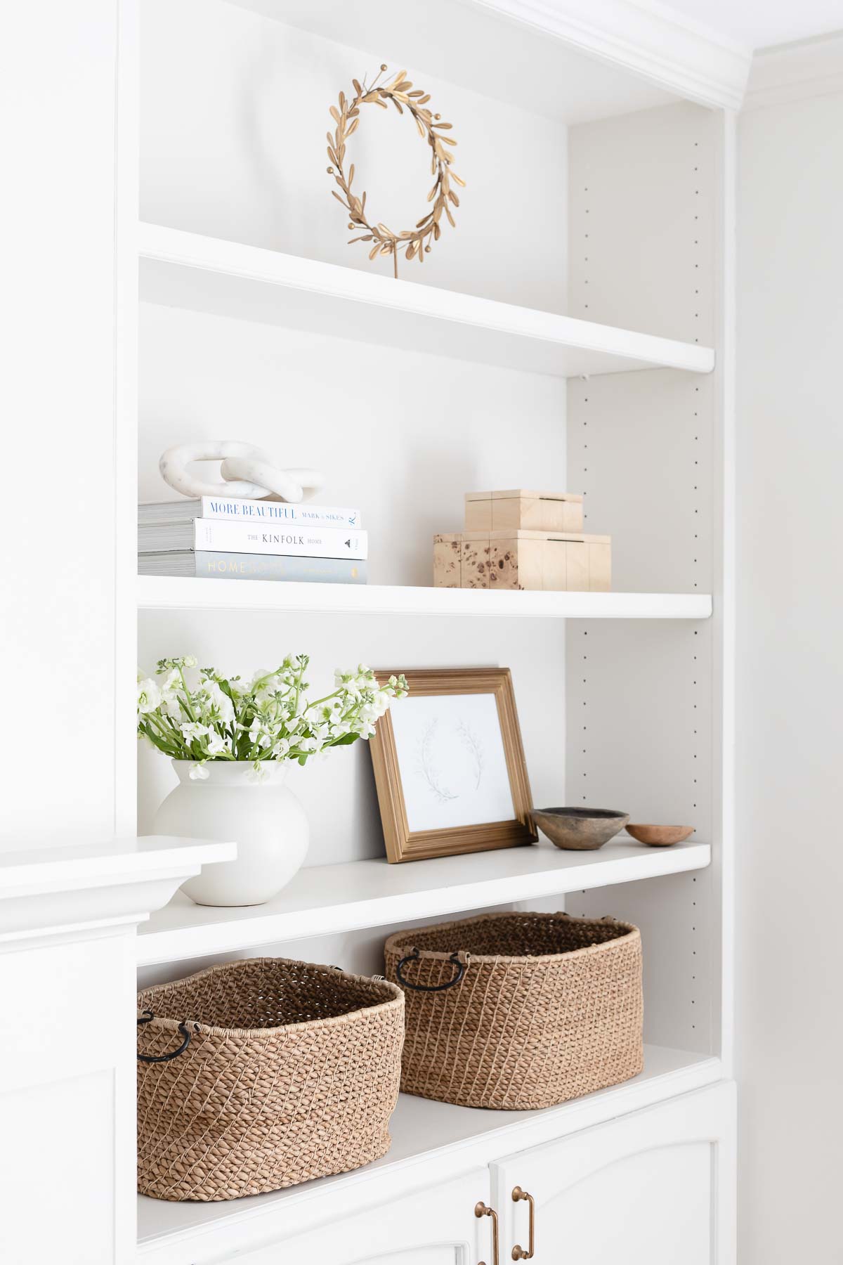 White built in bookshelves with minimalist decor.