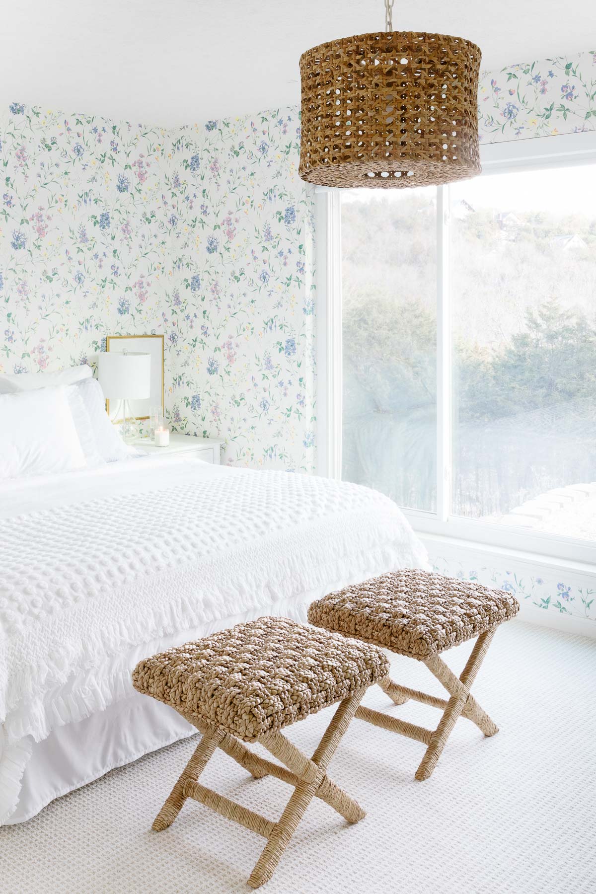 a bedroom with floral wallpaper and white bedroom and minimalist decor.