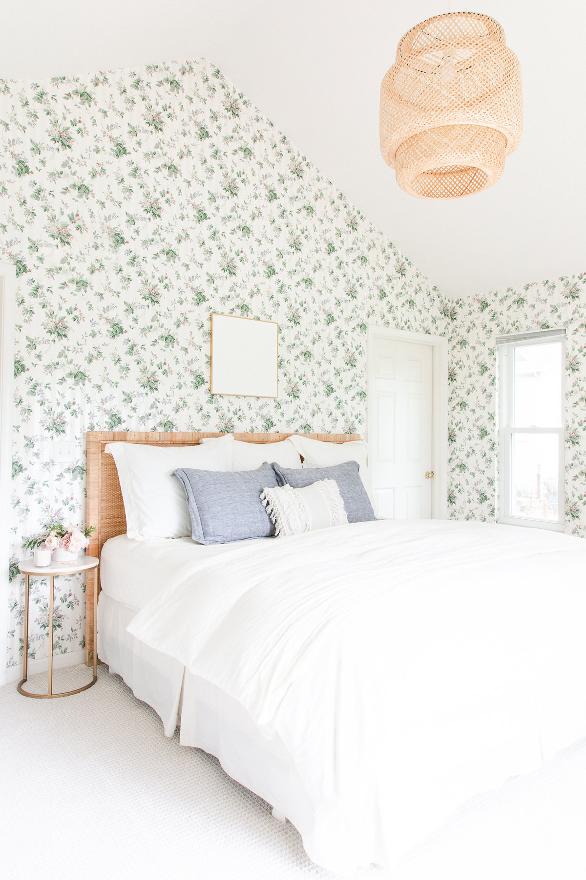 a bedroom with floral wallpaper and white bedroom and minimalist decor.