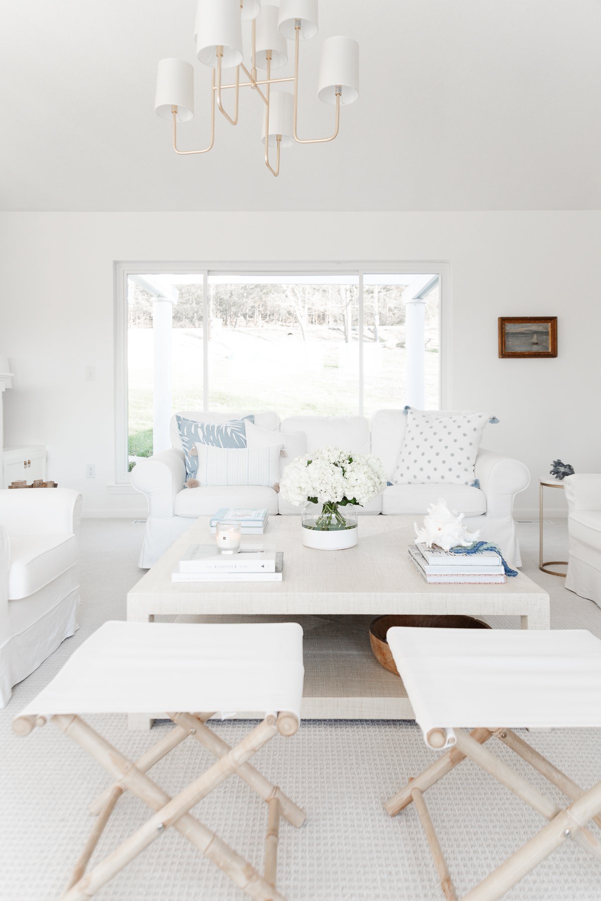 A living room with white walls, white furniture and minimalist decorating