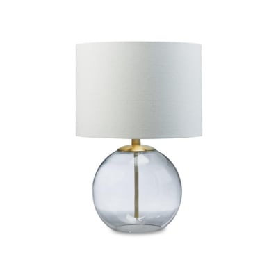 A clear glass table lamp with a white shade, perfect for achieving the pottery barn look for less.