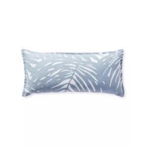 A blue and white pillow with palm leaves on it, resembling serena and lily dupes.
