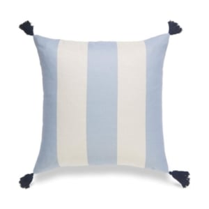 A blue and white striped pillow with tassels gives off a serene and chic vibe, offering a similar style to the Serena and Lily look for less.