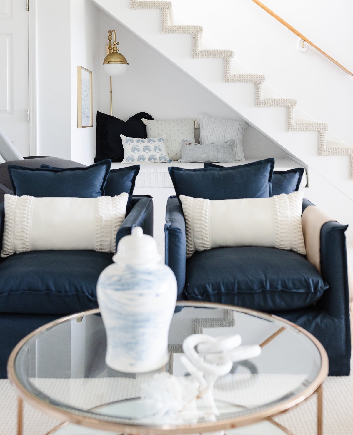 white and blue living room with rattan and brass accents