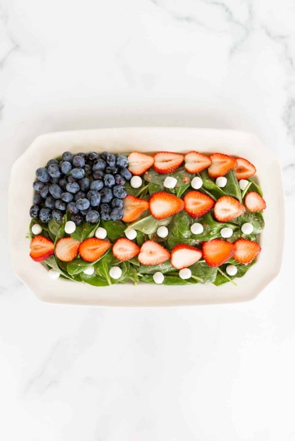 Red white and blue fruit salad designed as American flag on a white platter