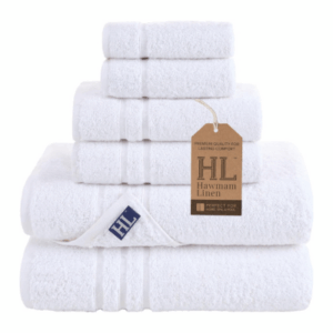 A stack of white towels in various sizes, labeled "Hawamam Linen" with a brown tag attached—perfect for elevating any guest room.