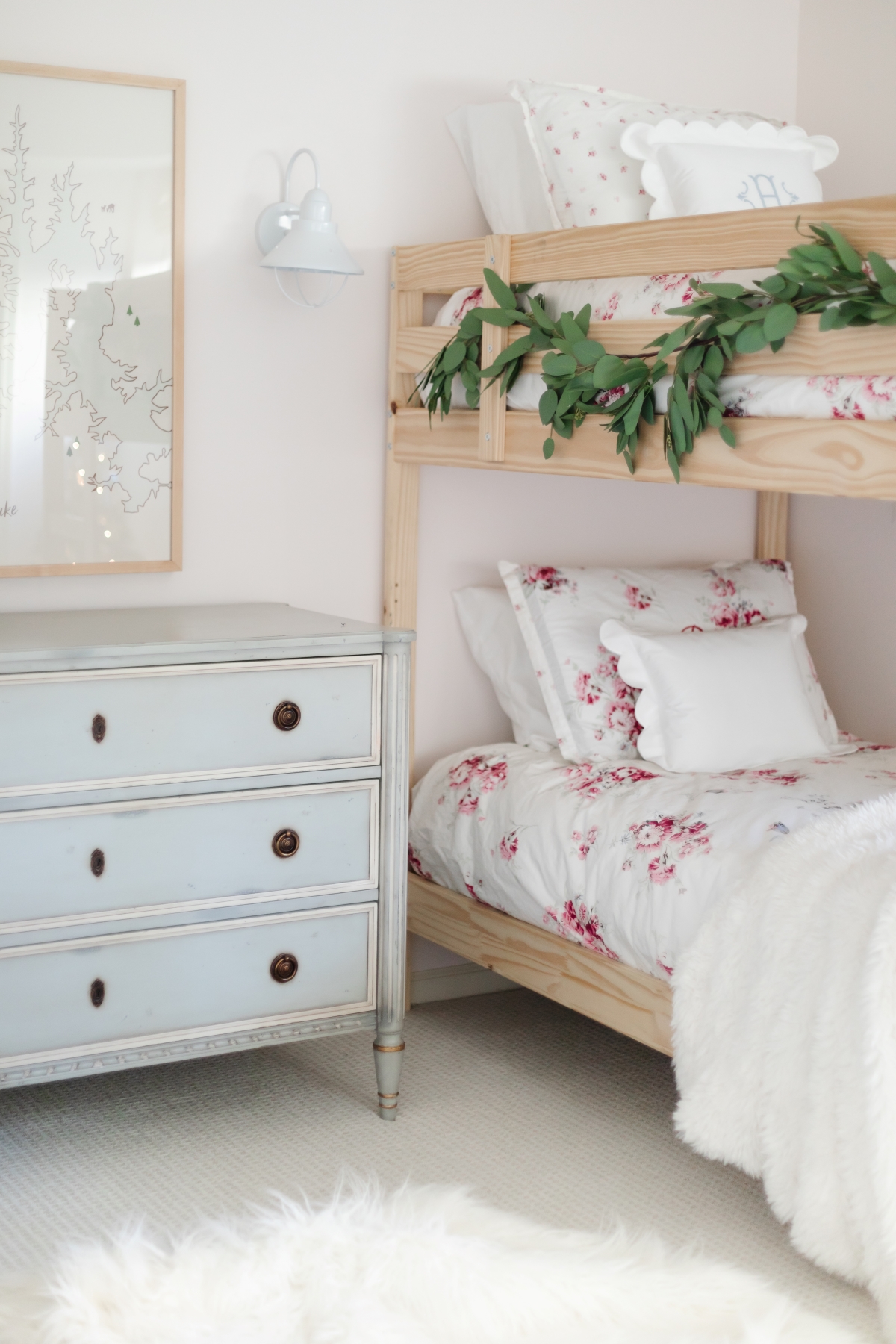 A girl's bunk room with pink bedding and Benjamin Moore Pink Bliss paint on the walls.