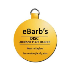 Round yellow tag labeled "eBarb’s DISC ADHESIVE PLATE HANGER, Made in England, See our store for all 5 sizes," with a small metal loop at the top—perfect for securing your plates with reliable plate hangers.