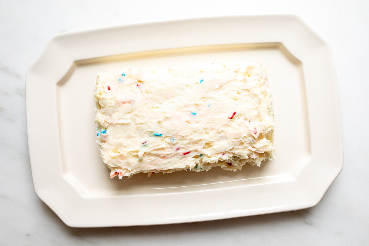 A funfetti dip flag in the process of being frosted.