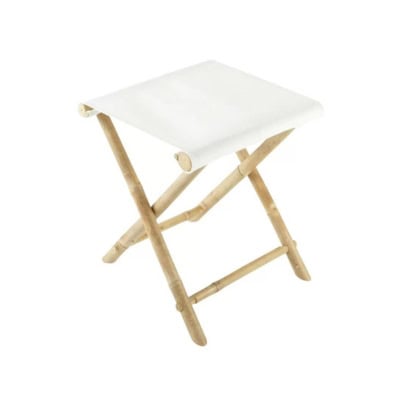 A wooden folding stool with a white canvas seat, perfect for the guest room. The stool features a simple X-frame design for portability and compact storage.