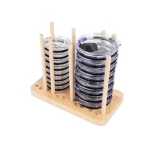 A wooden rack holding multiple stacks of kitchen gadgets.